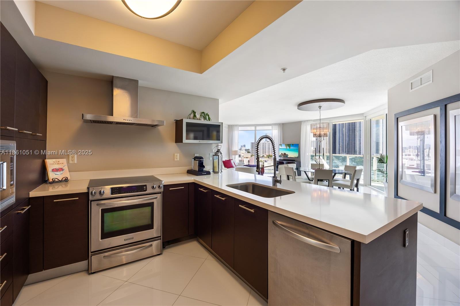 250 Sunny Isles Boulevard, Unit 31202 Sunny Isles Beach, FL 33160 - Photo 5 of 28 a kitchen with a sink stove and microwave