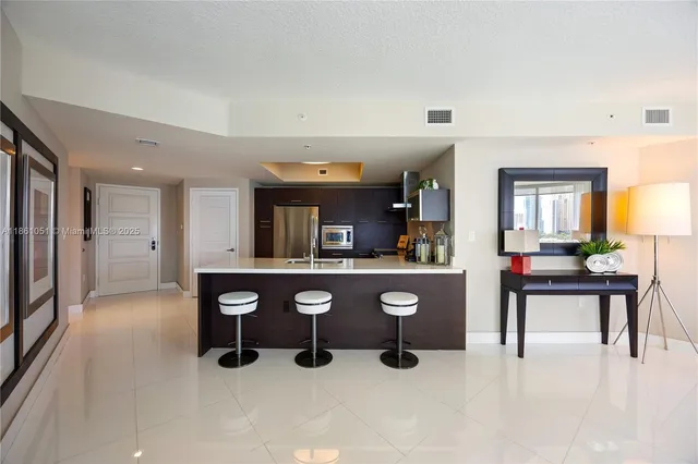 a living room with stainless steel appliances kitchen island granite countertop furniture and a kitchen view
