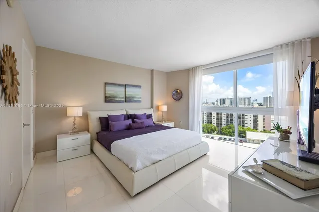 a bedroom with a bed and a large window