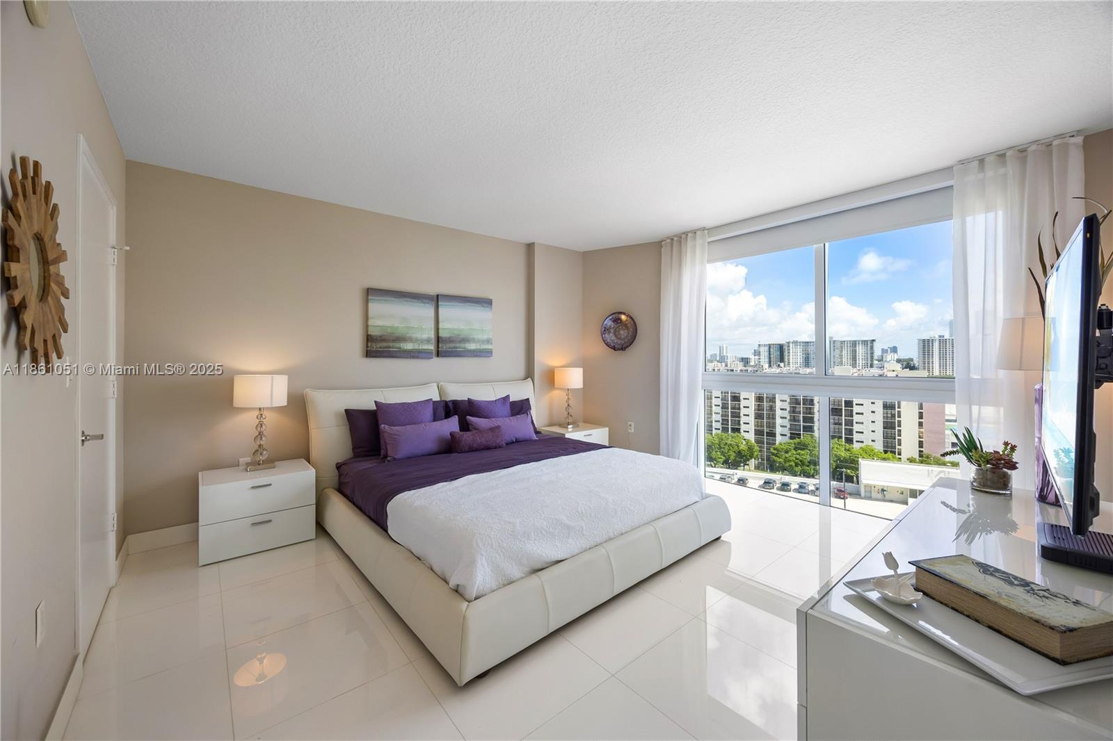 250 Sunny Isles Boulevard, Unit 31202 Sunny Isles Beach, FL 33160 - Photo 8 of 28 a bedroom with a bed and a large window