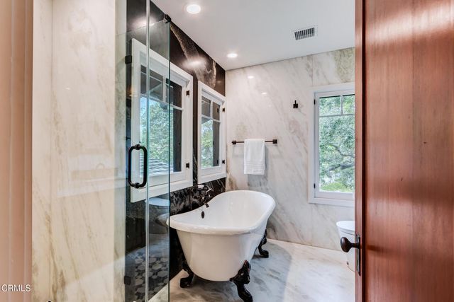 a bedroom with bed and a large mirror