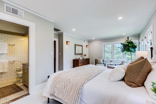 a bedroom with a bed and a large window