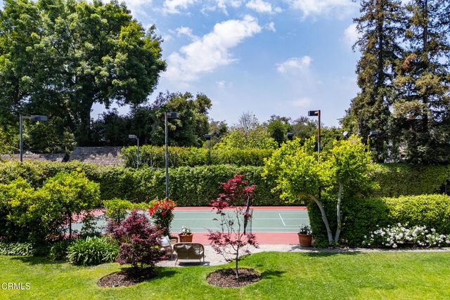 a view of a patio with table and chairs and potted plants
