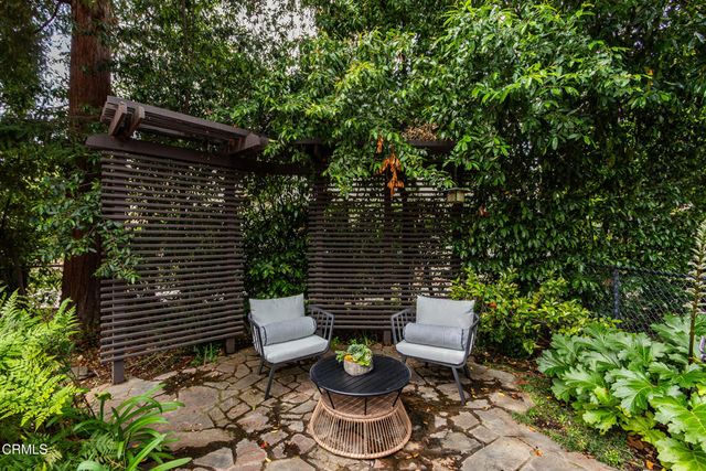 a view of a house with a big yard and potted plants