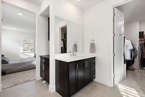 a bathroom with a tub sink and mirror