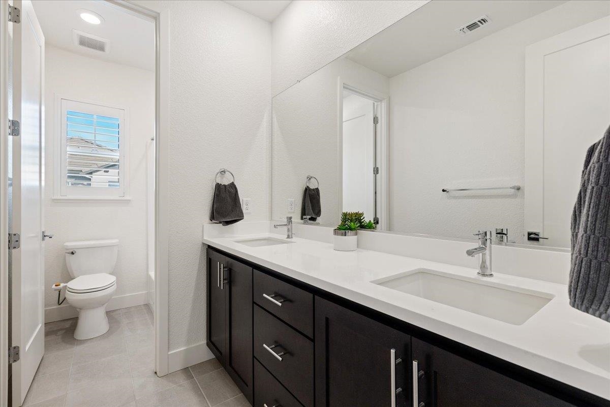 2005 Davoli Court San Ramon, CA 94583 - Photo 29 of 45 Upstairs Full Bathroom with double vanity, a textured wall, and light tile patterned flooring