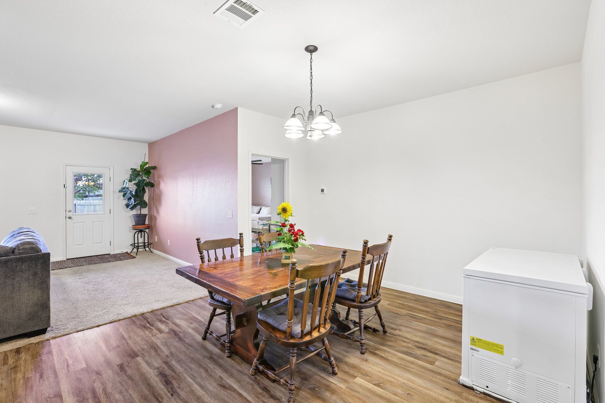 19105 Mike Mansfield Road Manor, TX 78653 - Photo 10 of 28 a view of a dining room with furniture and wooden floor