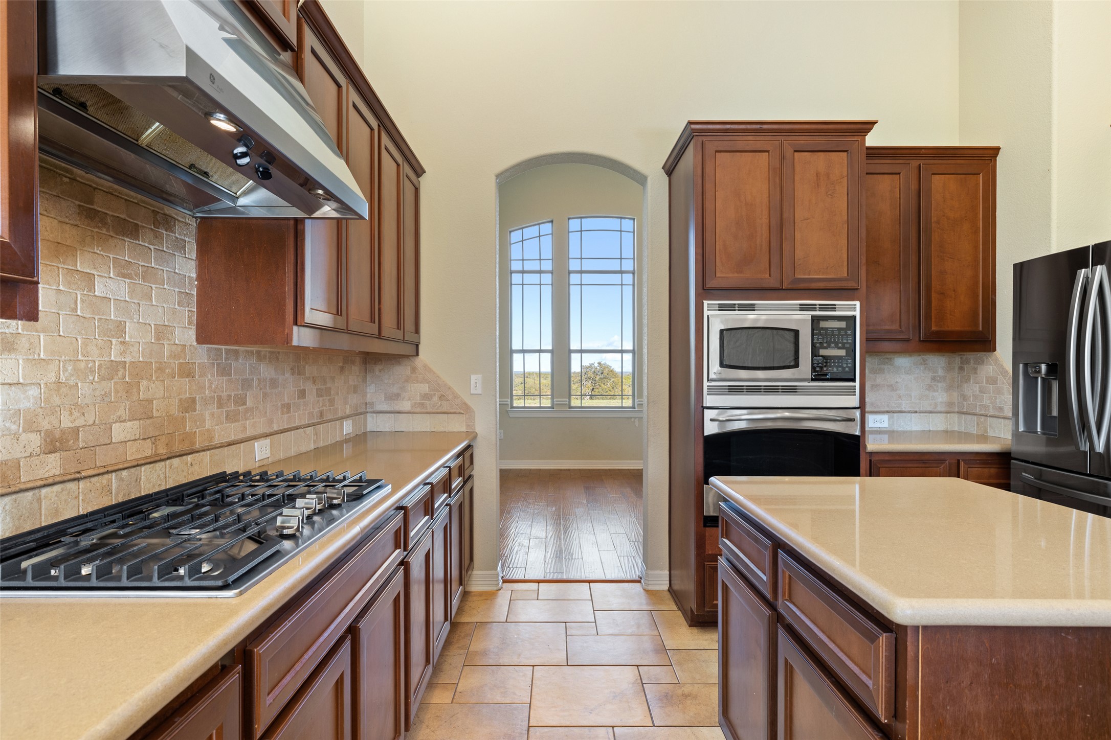 118 Landons Way Blanco, TX 78606 - Photo 24 of 32 a kitchen with stainless steel appliances granite countertop a stove a microwave and a refrigerator