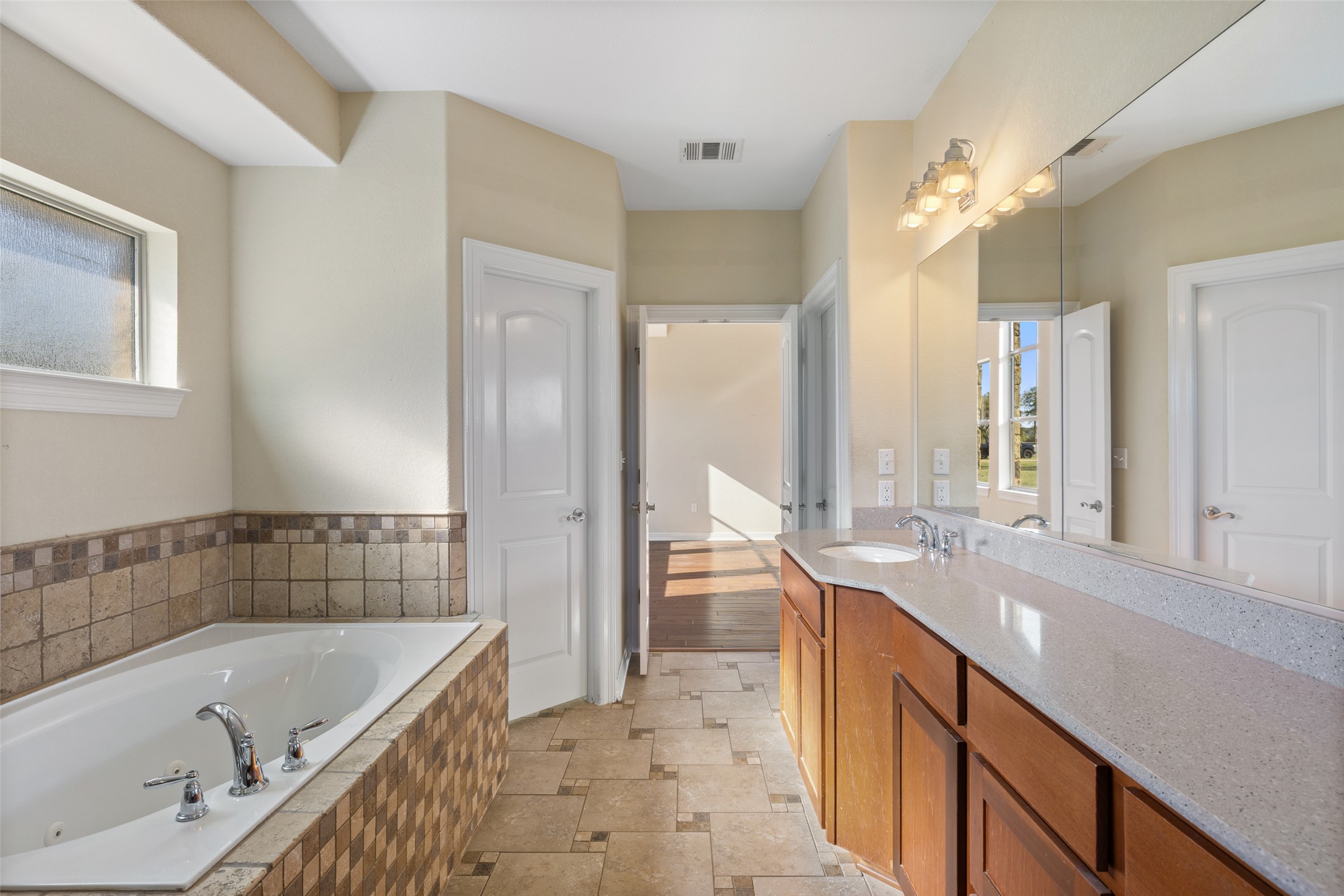 118 Landons Way Blanco, TX 78606 - Photo 32 of 32 a bathroom with a tub a sink and a large mirror