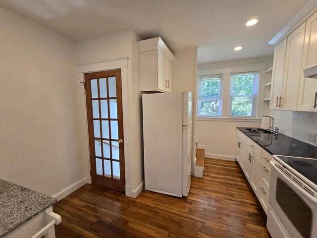 a kitchen with stainless steel appliances granite countertop a refrigerator and a sink