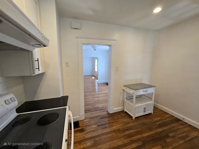 a view of room with wooden floor and cabinets