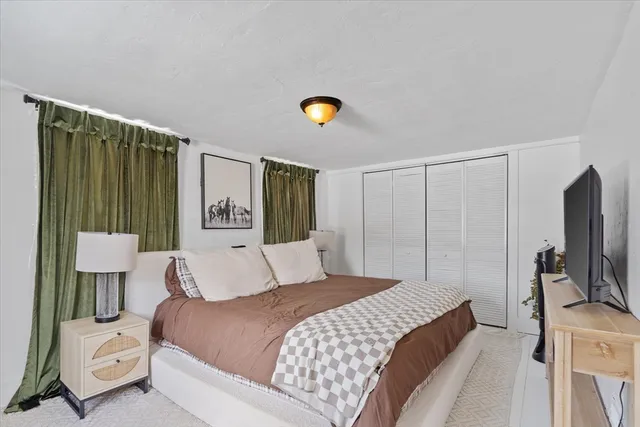 a bedroom with a bed and a lamp