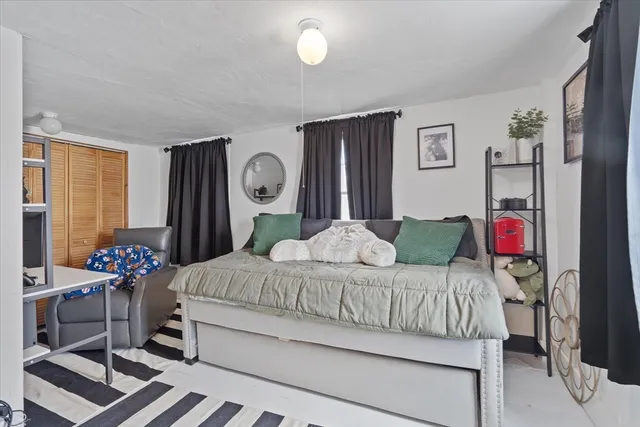 a view of a white house with a yard