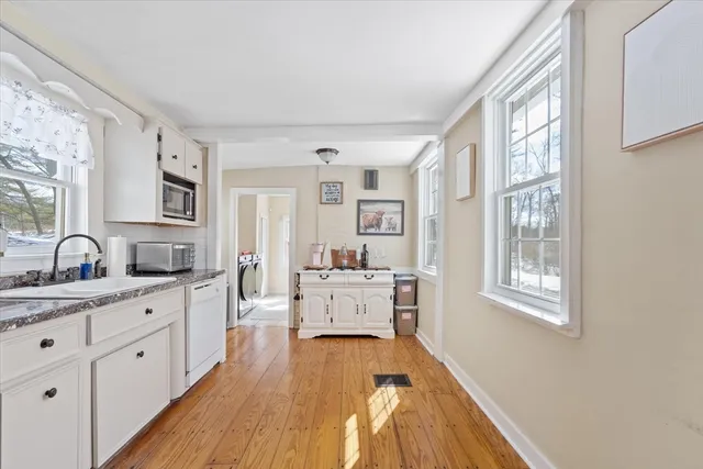 a large white kitchen with cabinets
