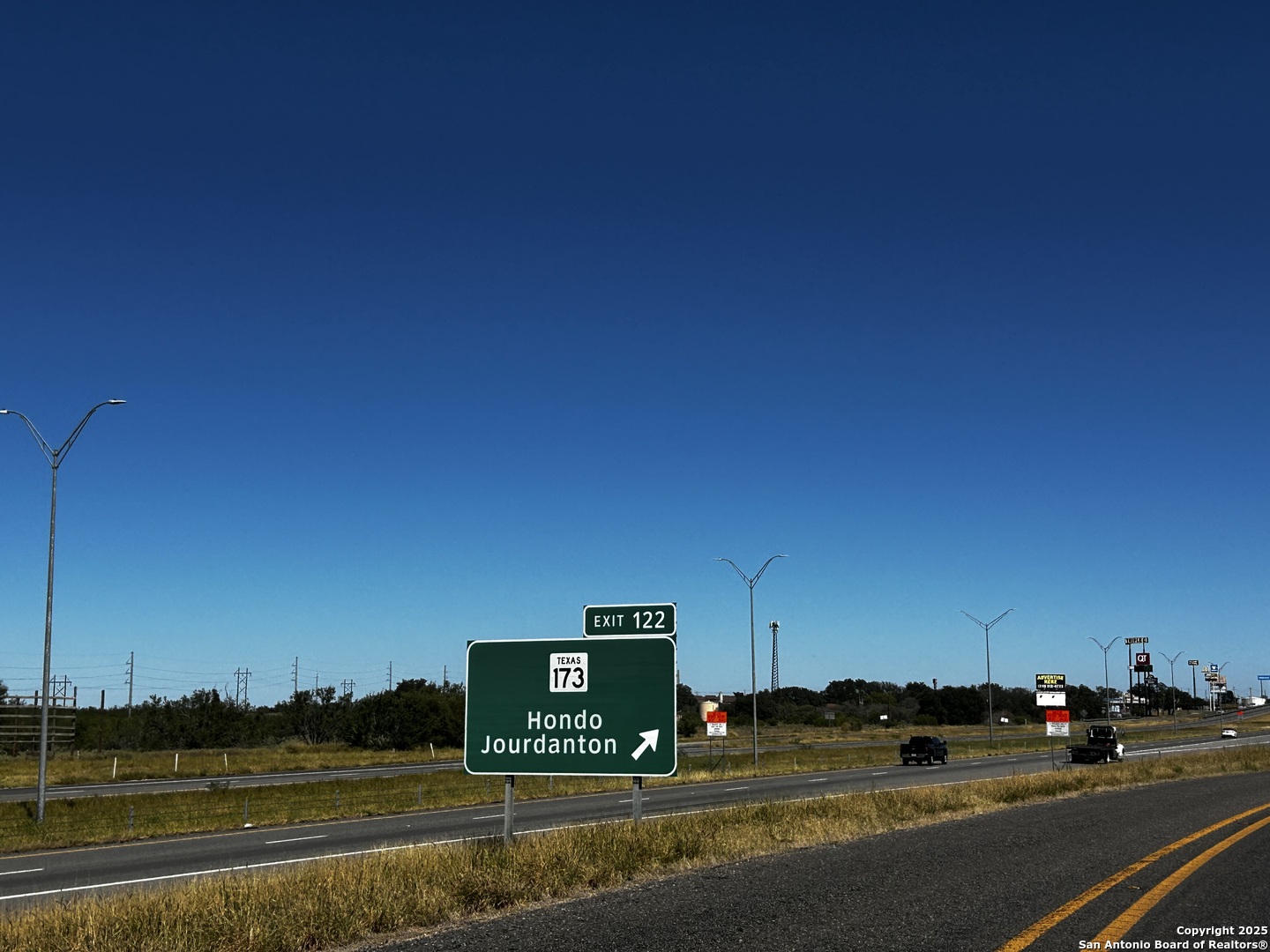 Tbd County Road 777 Devine, TX 78016 - Photo 3 of 4 a view of city street with a cars parked