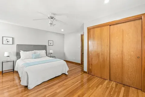 a bedroom with a large bed and a large window