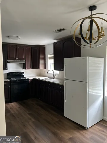 a kitchen with a refrigerator and a sink