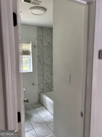 a bathroom with a toilet and shower