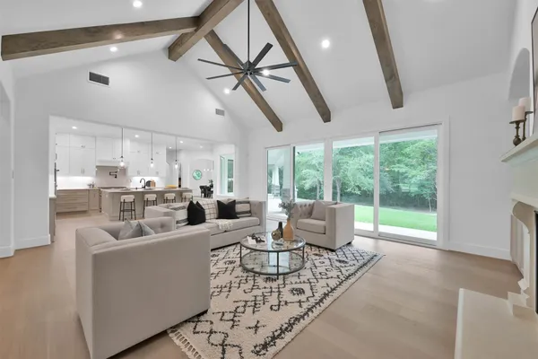 a living room with furniture and a floor to ceiling window