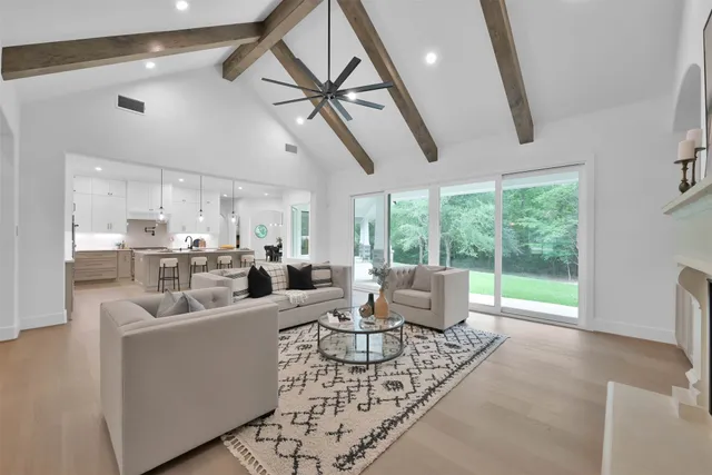 a living room with furniture and a floor to ceiling window