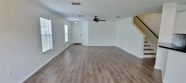 wooden floor in an empty room with a window