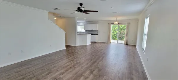 a view of a kitchen with a sink and wooden floor