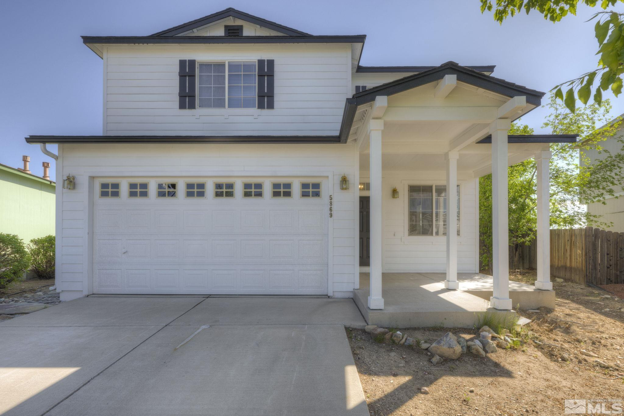 5869 September Circle Reno, NV 89523 - Photo 1 of 21 a view of a brick house with large windows and a small yard