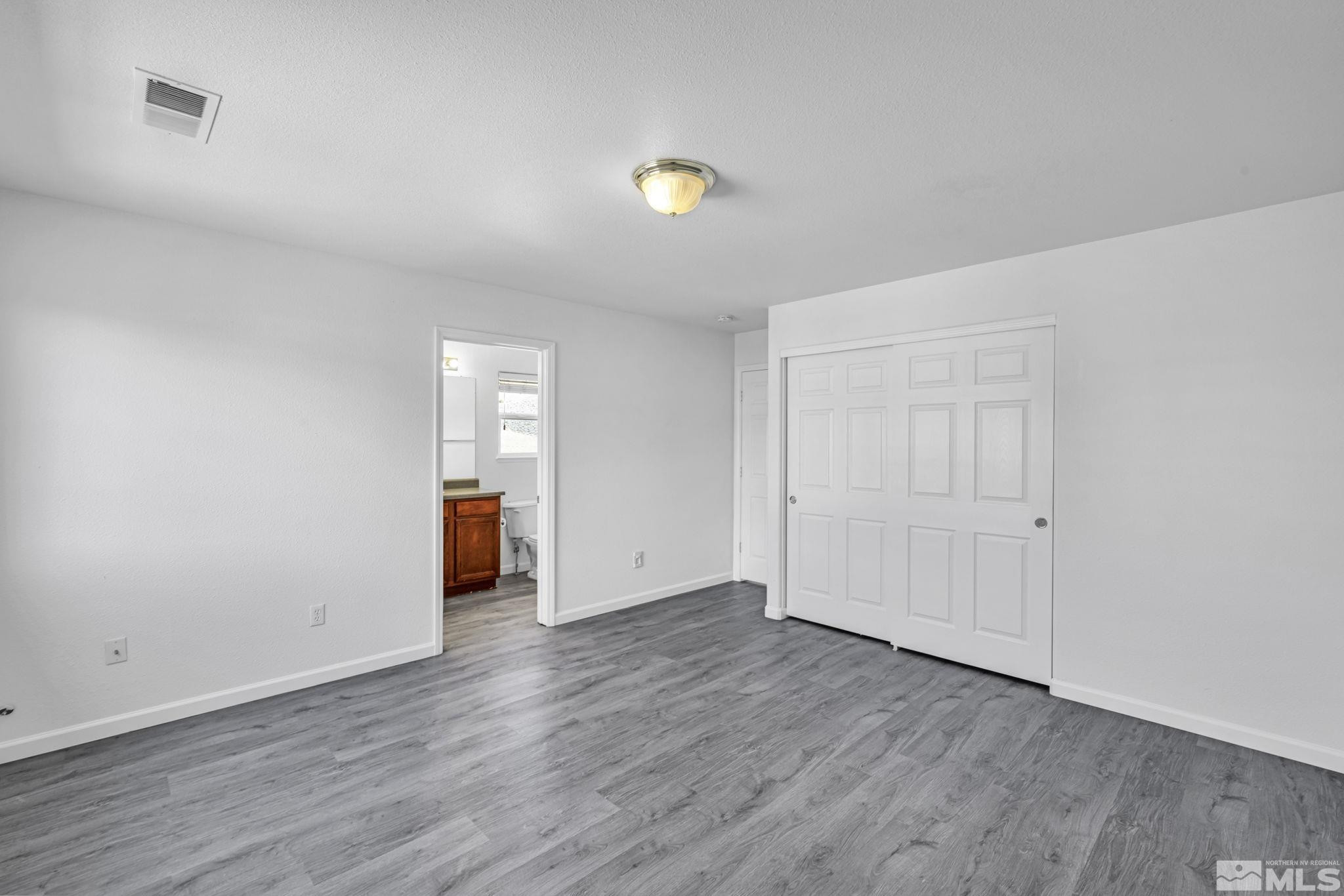 5869 September Circle Reno, NV 89523 - Photo 11 of 21 a view of an empty room with wooden floor and a window