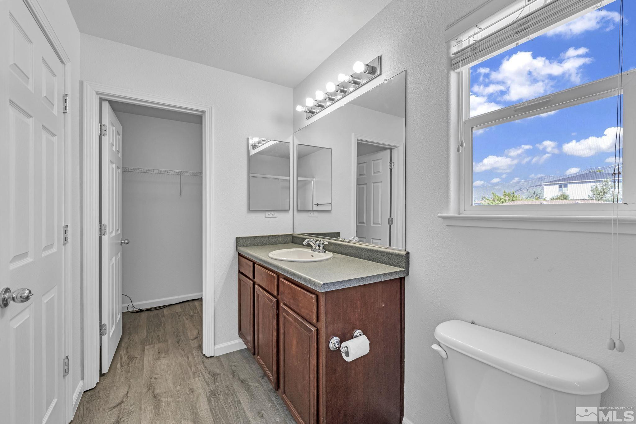 5869 September Circle Reno, NV 89523 - Photo 13 of 21 a bathroom with a toilet sink and mirror
