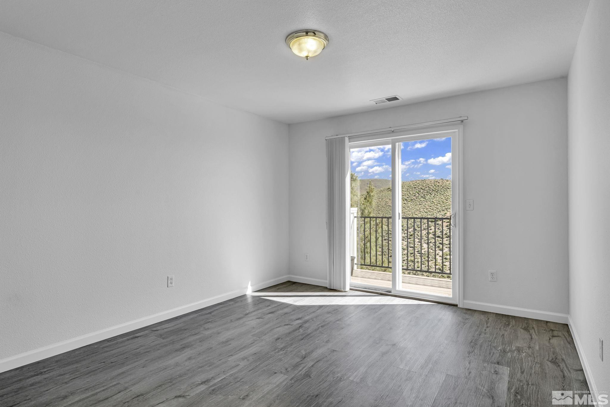 5869 September Circle Reno, NV 89523 - Photo 14 of 21 a view of an empty room with wooden floor and a window
