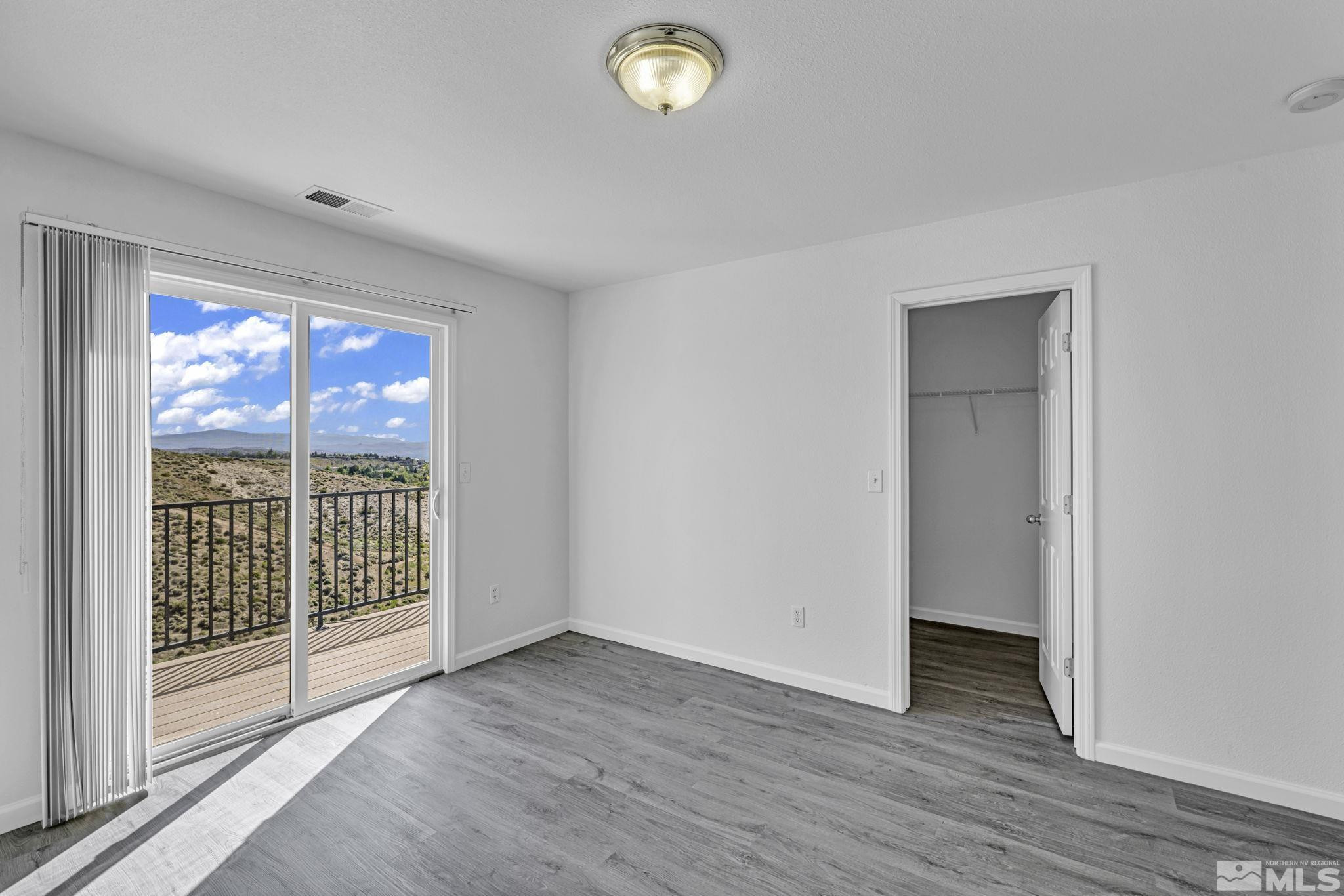 5869 September Circle Reno, NV 89523 - Photo 15 of 21 a view of empty room with wooden floor and fan