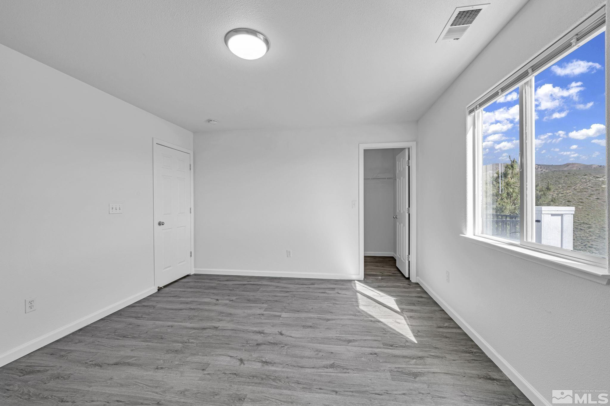 5869 September Circle Reno, NV 89523 - Photo 17 of 21 a view of an empty room with wooden floor and a window