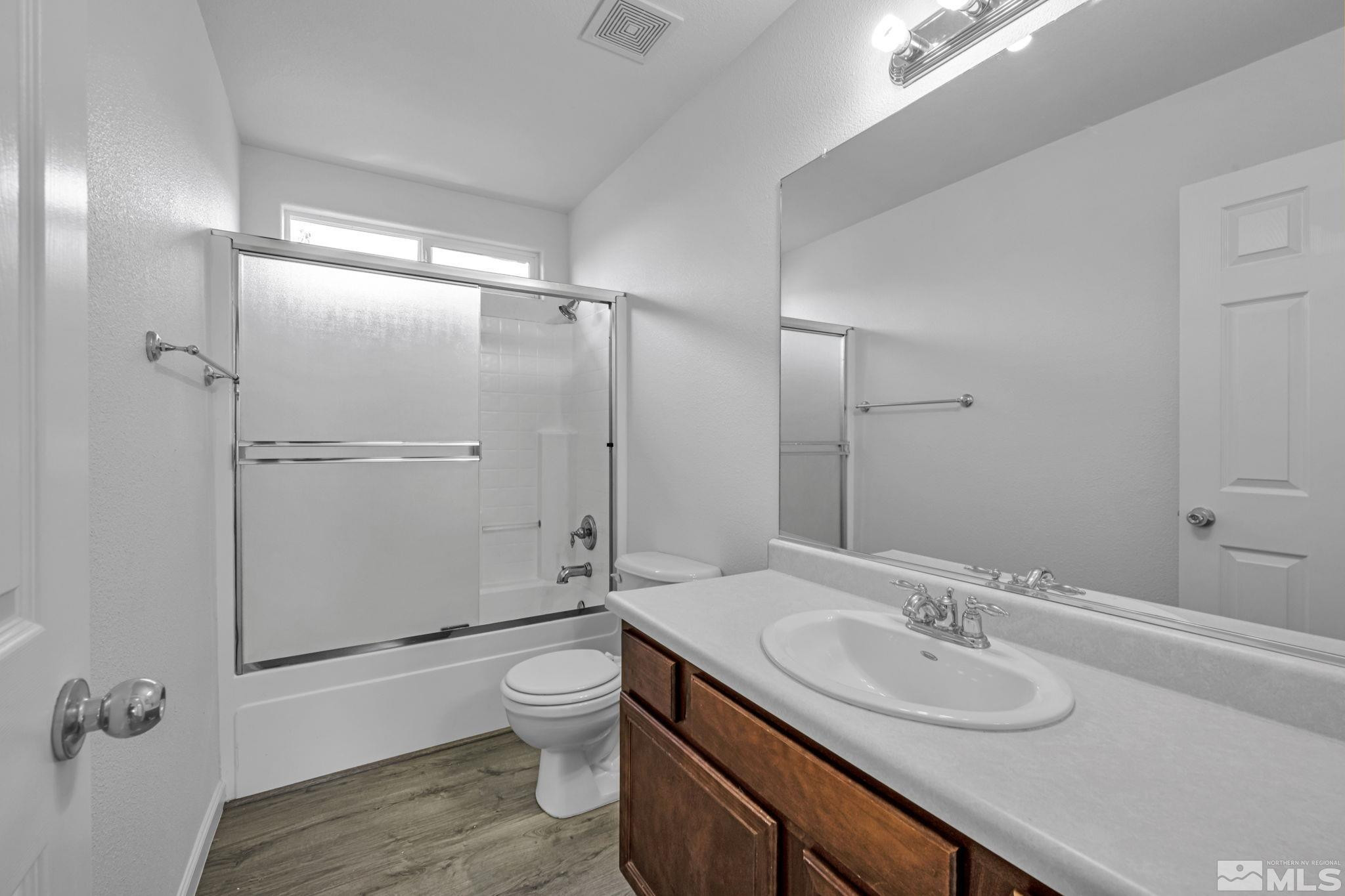 5869 September Circle Reno, NV 89523 - Photo 18 of 21 a bathroom with a sink toilet double vanity and shower