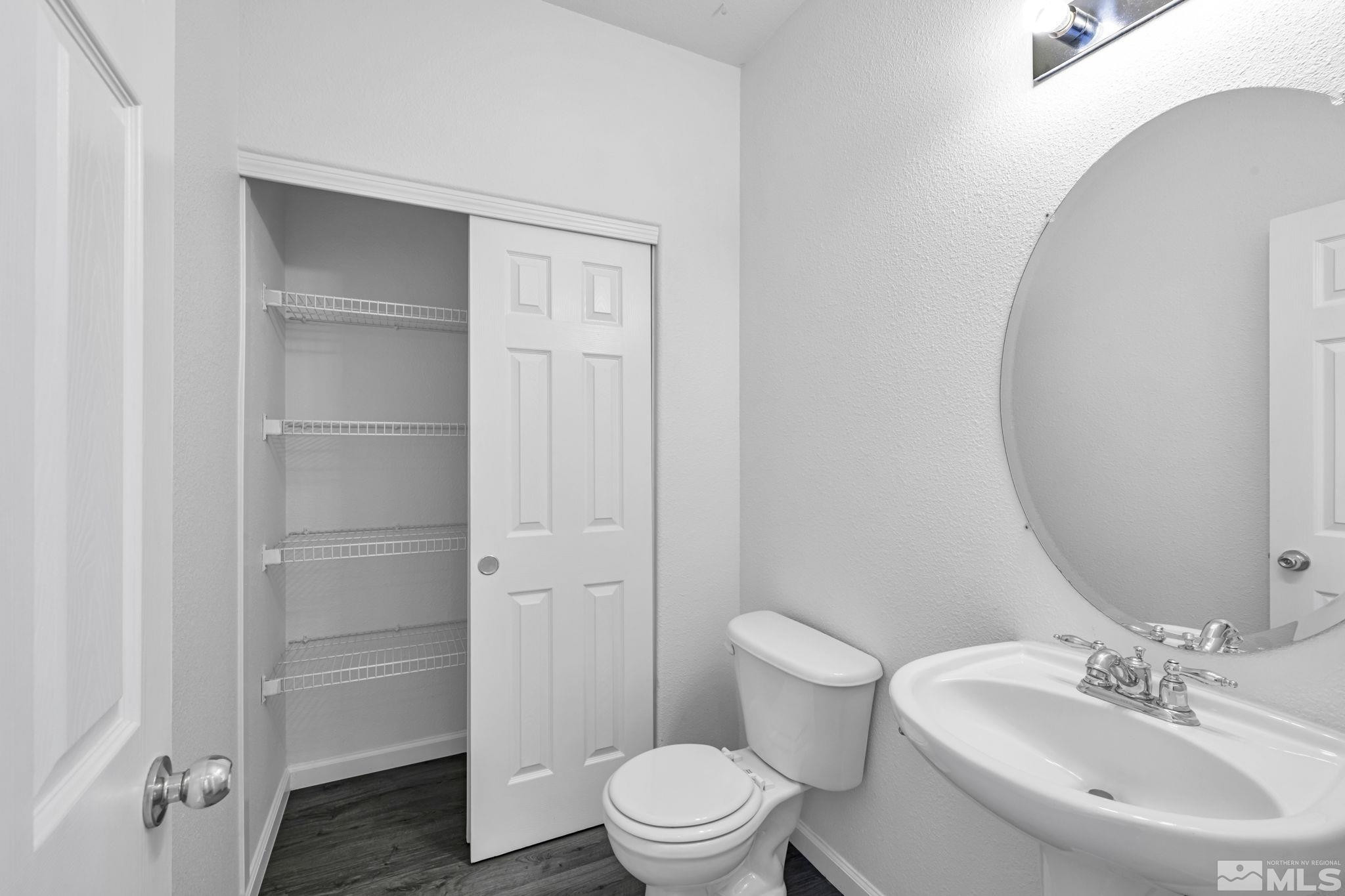 5869 September Circle Reno, NV 89523 - Photo 20 of 21 a bathroom with a toilet a sink and a mirror