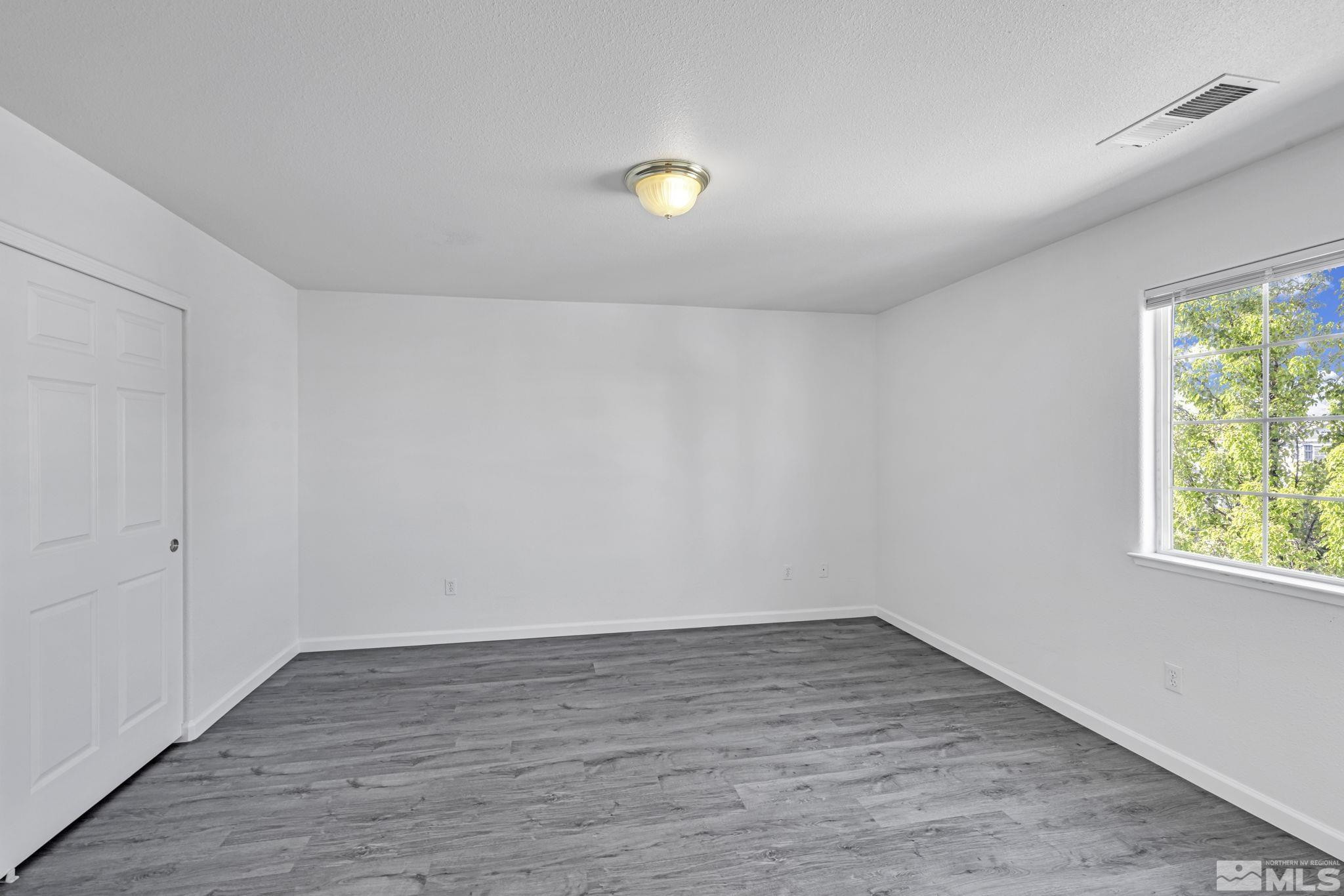 5869 September Circle Reno, NV 89523 - Photo 10 of 21 wooden floor in an empty room with a window