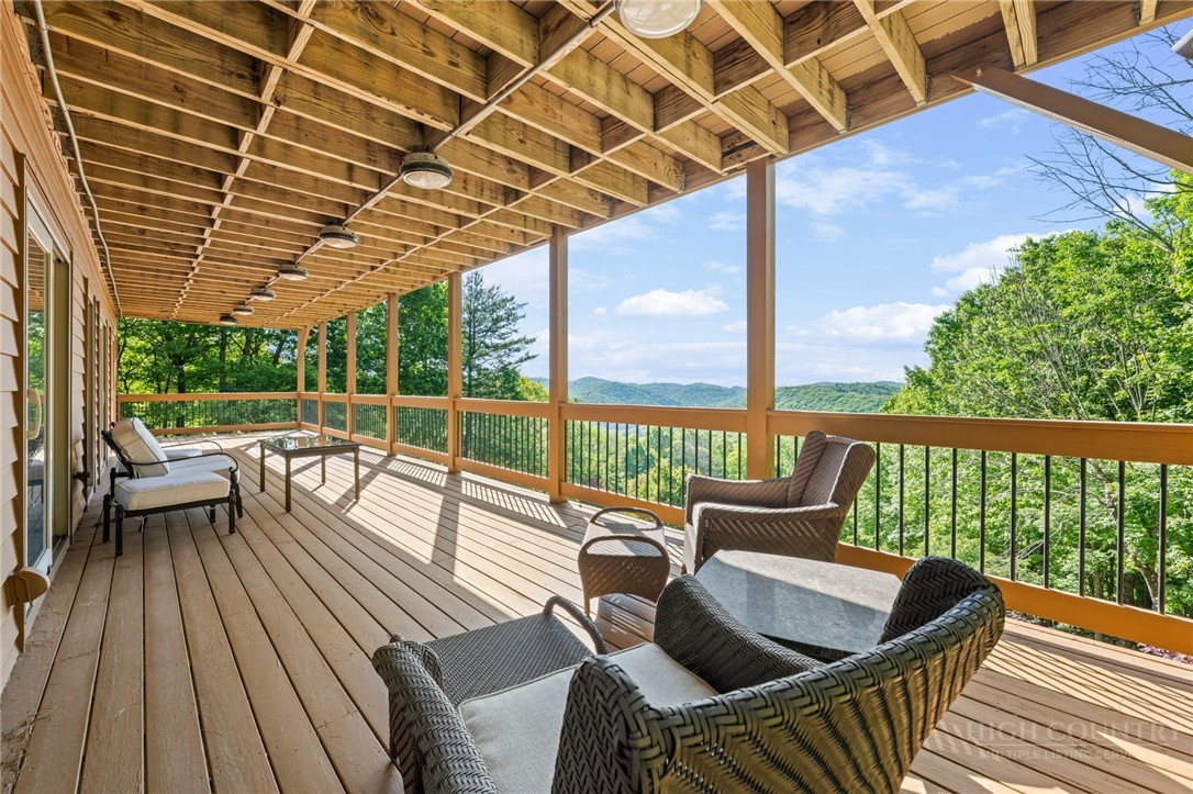 331 Alpine Road Blowing Rock, NC 28605 - Photo 7 of 50 a view of balcony with couch and wooden floor