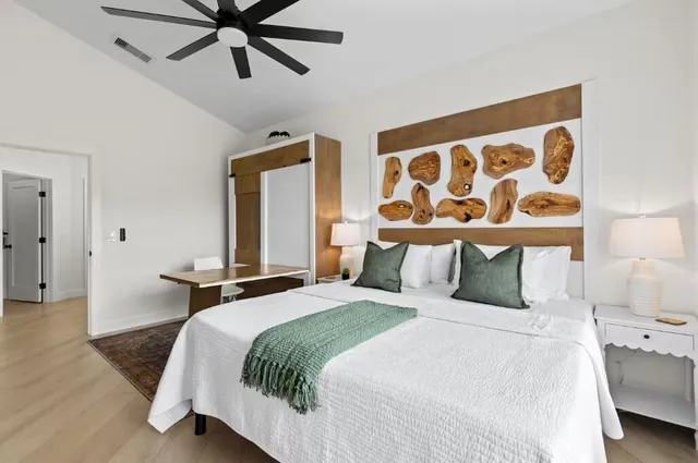 a bedroom with a bed and lamp