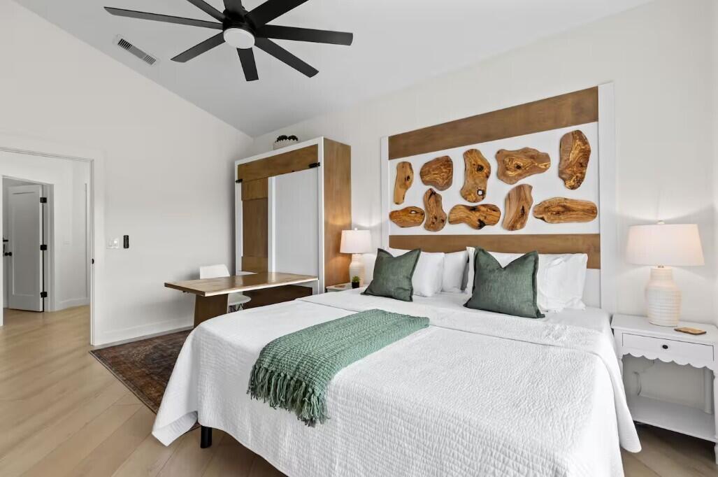 9843 Perfect Drive, Unit A Port St. Lucie, FL 34986 - Photo 1 of 8 a bedroom with a bed and lamp