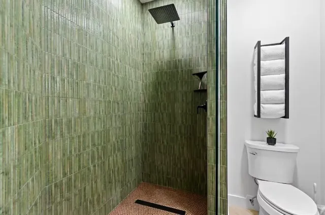 a bathroom with a toilet and a shower