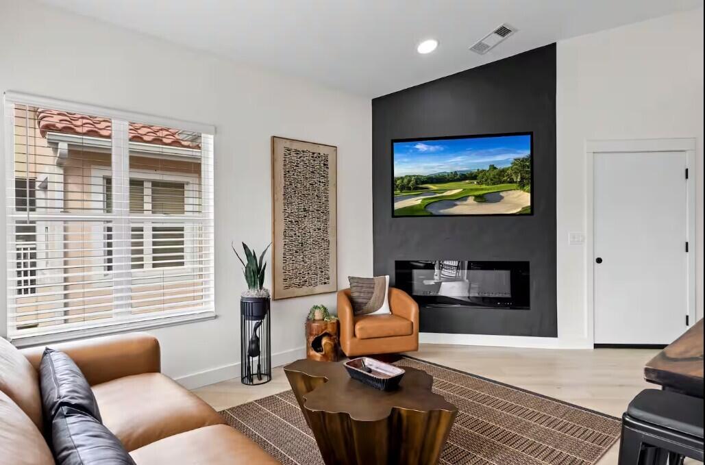 9843 Perfect Drive, Unit A Port St. Lucie, FL 34986 - Photo 5 of 8 a living room with furniture and a flat screen tv