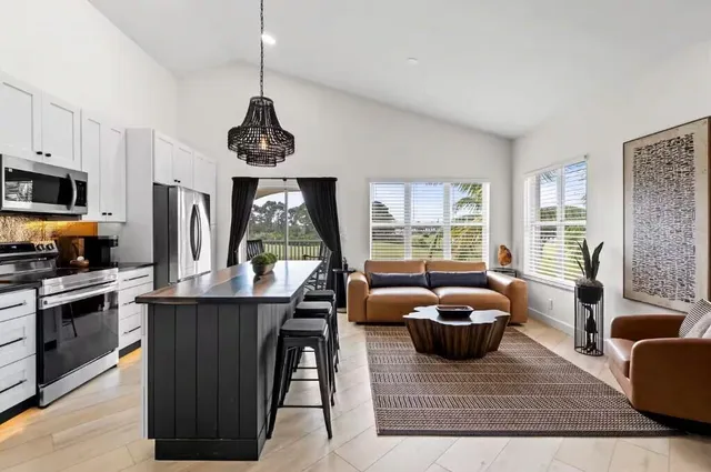 a living room with furniture a window and a table