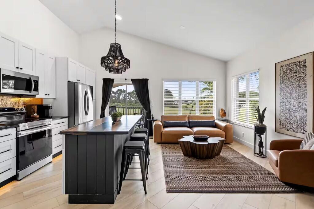 9843 Perfect Drive, Unit A Port St. Lucie, FL 34986 - Photo 8 of 8 a living room with furniture a window and a table