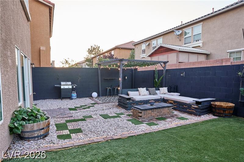 6302 Jackson Spring Road Las Vegas, NV 89118 - Photo 43 of 48 A private backyard oasis features an inviting patio area with a pergola and dedicated grilling space.