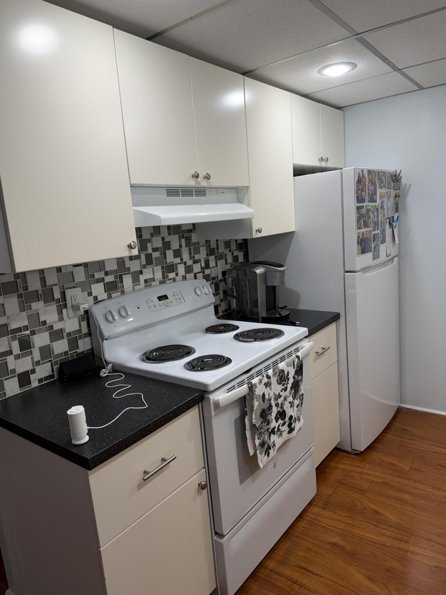 3062 Ainslie Drive Boca Raton, FL 33434 - Photo 11 of 27 a kitchen with a stove a sink and a refrigerator