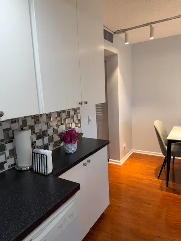 a kitchen with a sink and a stove top oven