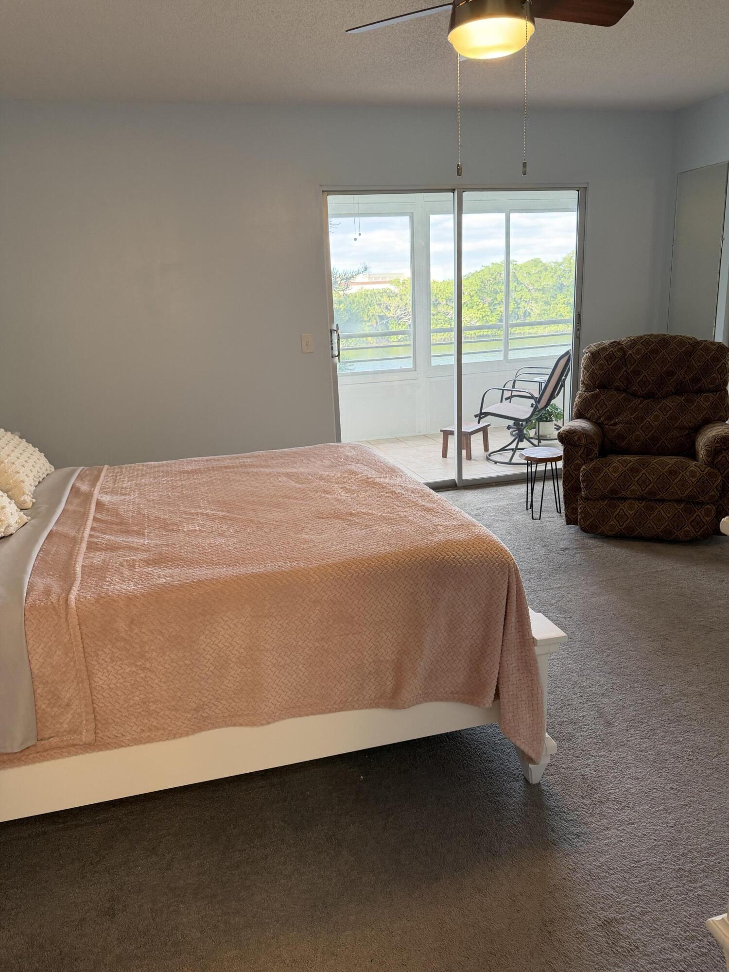 3062 Ainslie Drive Boca Raton, FL 33434 - Photo 24 of 27 a bedroom with a bed and a large window