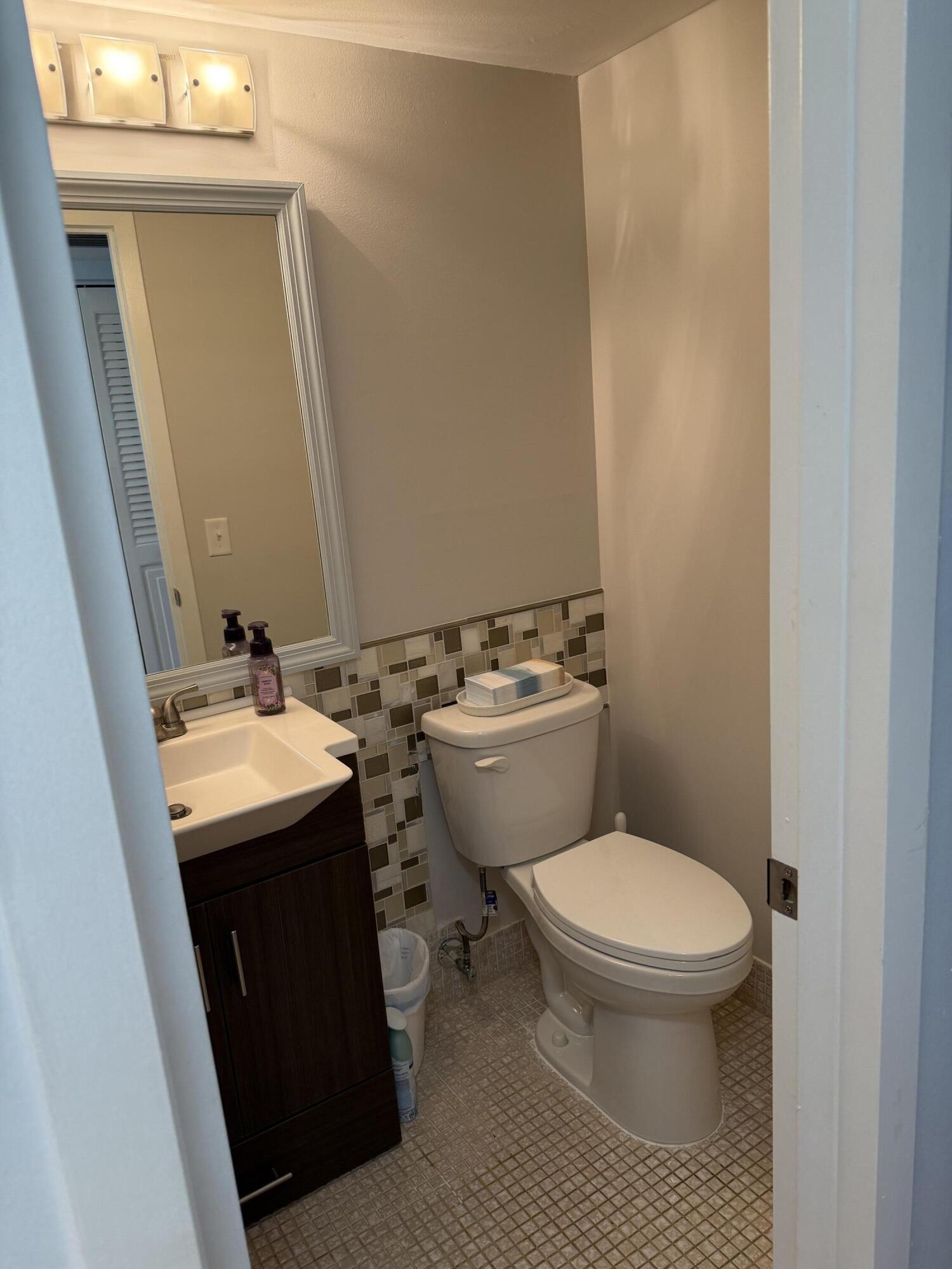 3062 Ainslie Drive Boca Raton, FL 33434 - Photo 26 of 27 a bathroom with a sink toilet and mirror