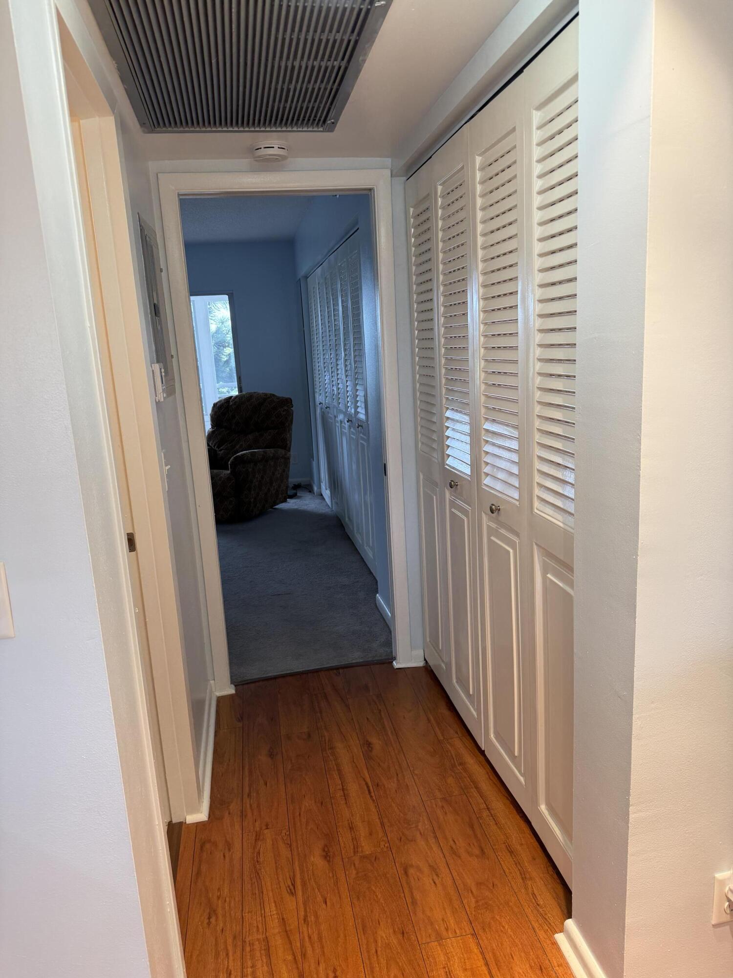3062 Ainslie Drive Boca Raton, FL 33434 - Photo 27 of 27 a view of a hallway with wooden floor and staircase