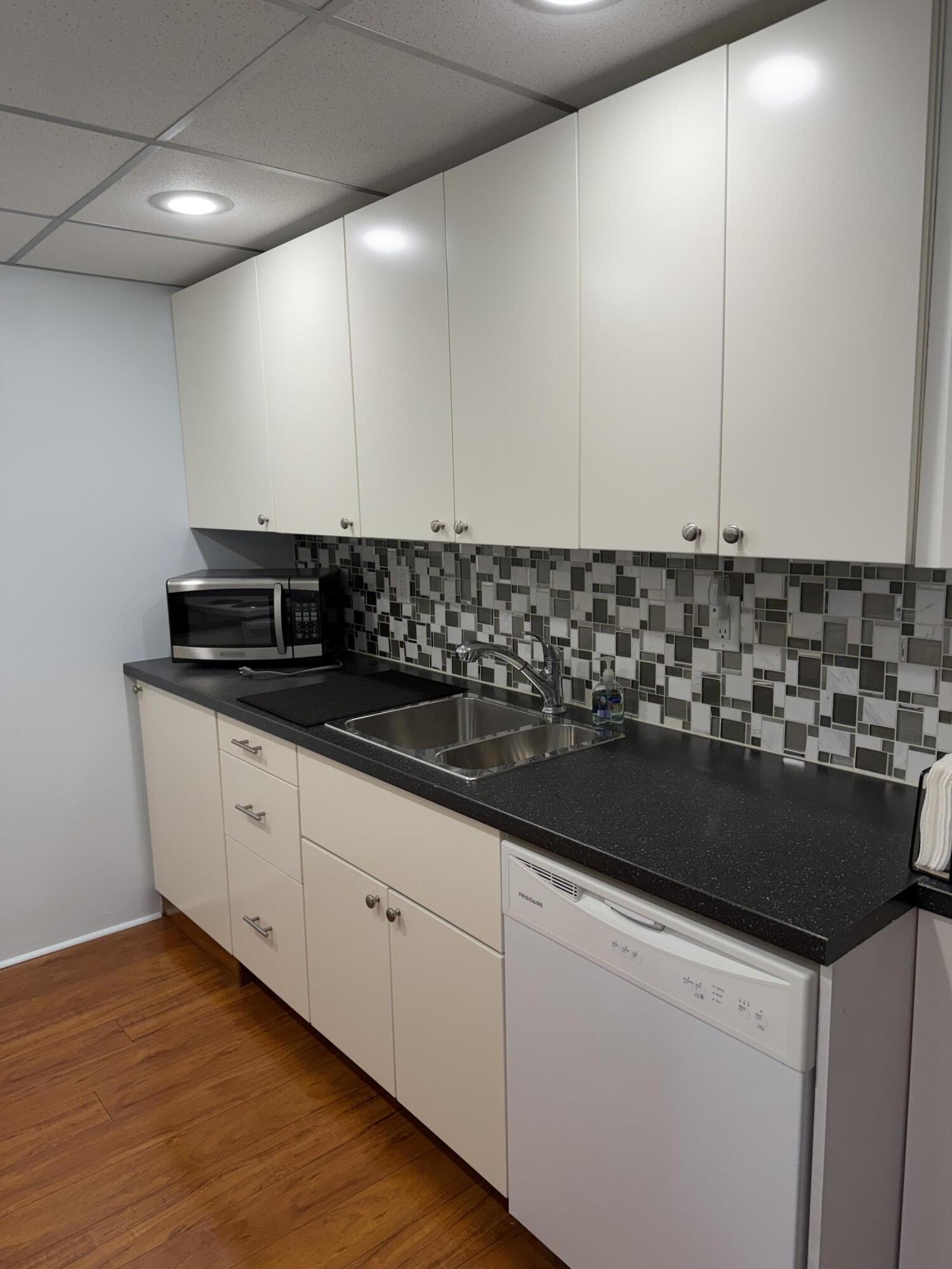 3062 Ainslie Drive Boca Raton, FL 33434 - Photo 10 of 27 a view of a kitchen counter space a sink and cabinets