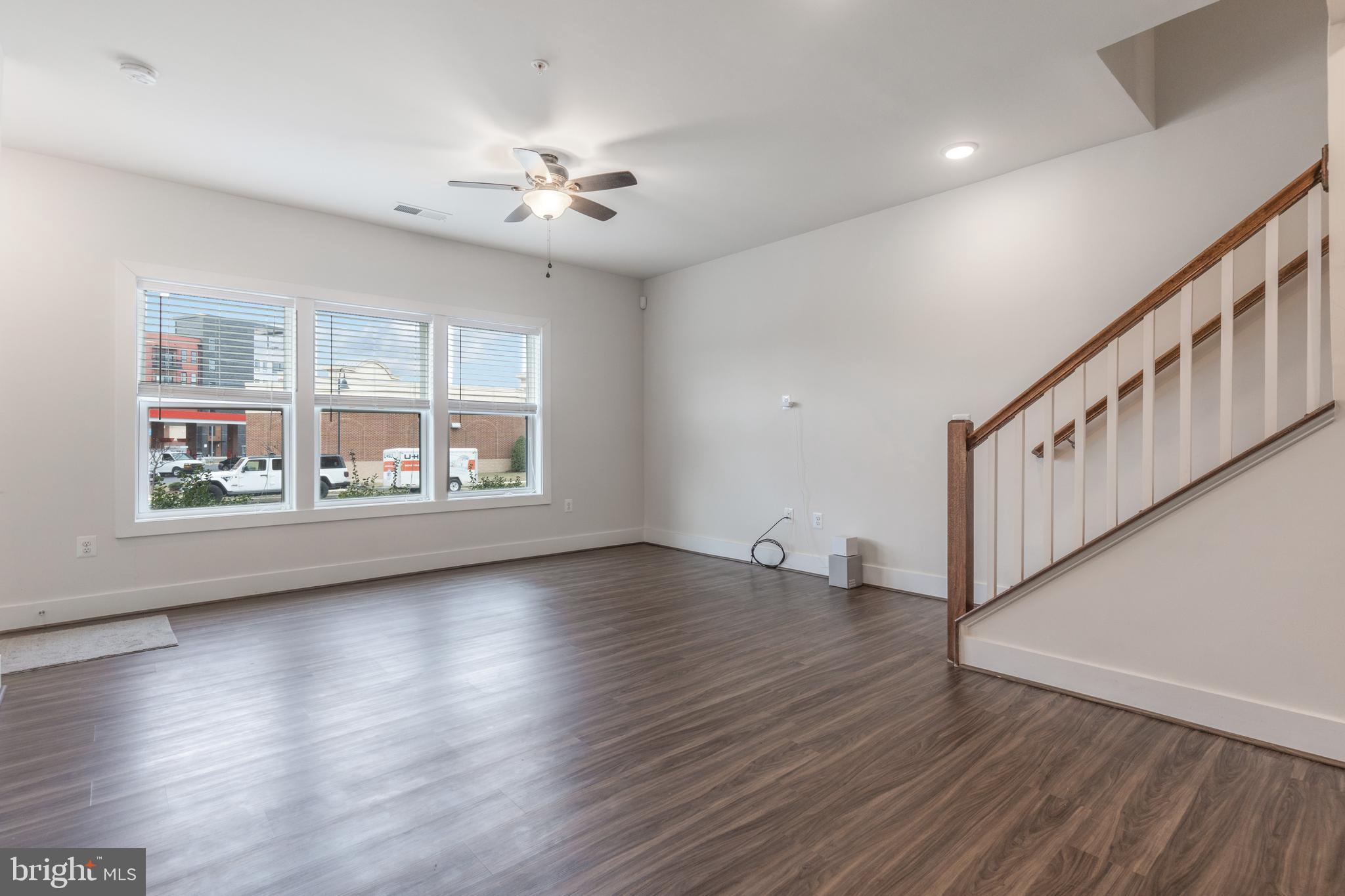 44730 Tiverton Square Ashburn, VA 20147 - Photo 3 of 39 a view of an empty room with wooden floor and a window